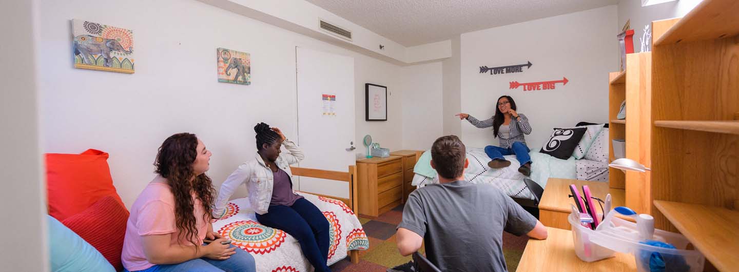 Students talking in a shared bedroom